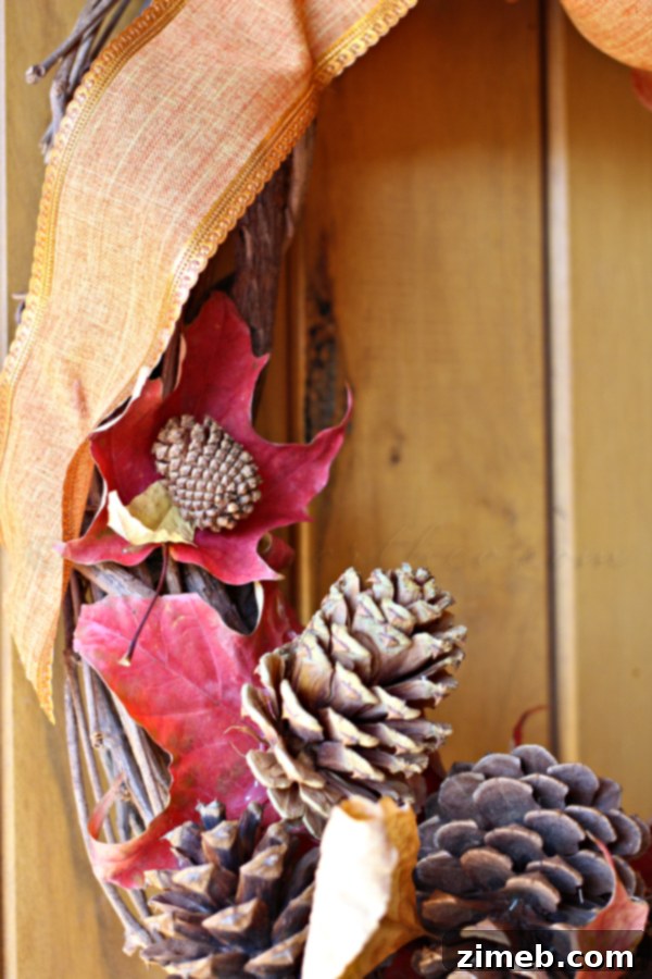 Crafting a fall wreath using freshly gathered leaves, pine cones, and a hot glue gun on a grapevine base.