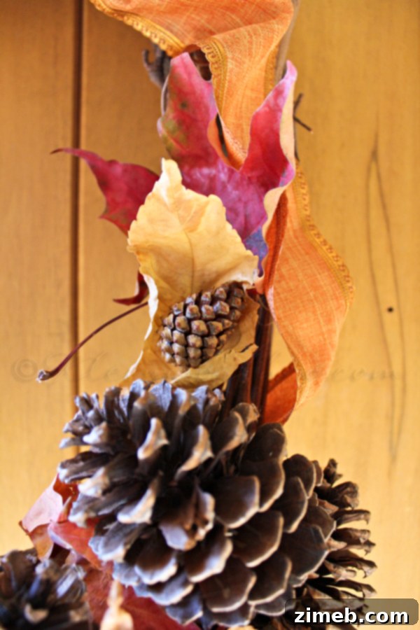 Proudly displaying a finished DIY fall wreath, handcrafted from North Idaho's abundant natural elements, on a front door.