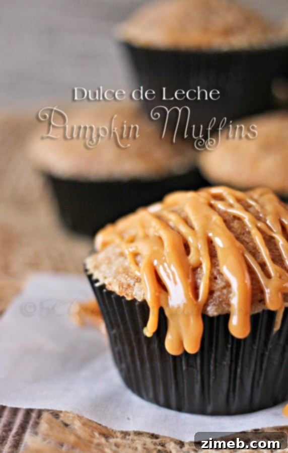 Hand holding a Dulce de Leche Pumpkin Muffin, inviting a bite