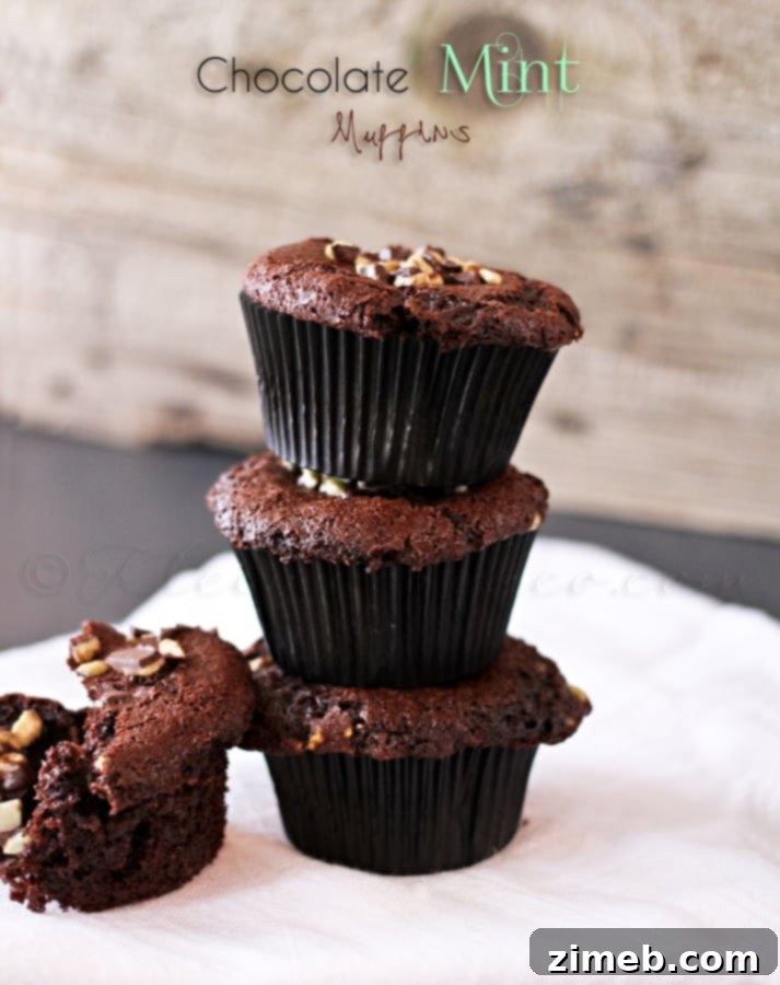 Close-up of a freshly baked Chocolate Mint Muffin, showing melted mint pieces on top