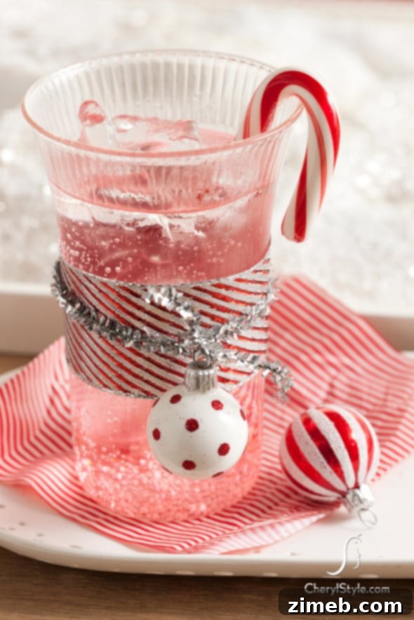 A stunning Pomegranate-Grenadine Sparkling Mocktail in a champagne flute, featuring a deep red hue and effervescent bubbles, garnished with fresh pomegranate seeds for a festive non-alcoholic option.
