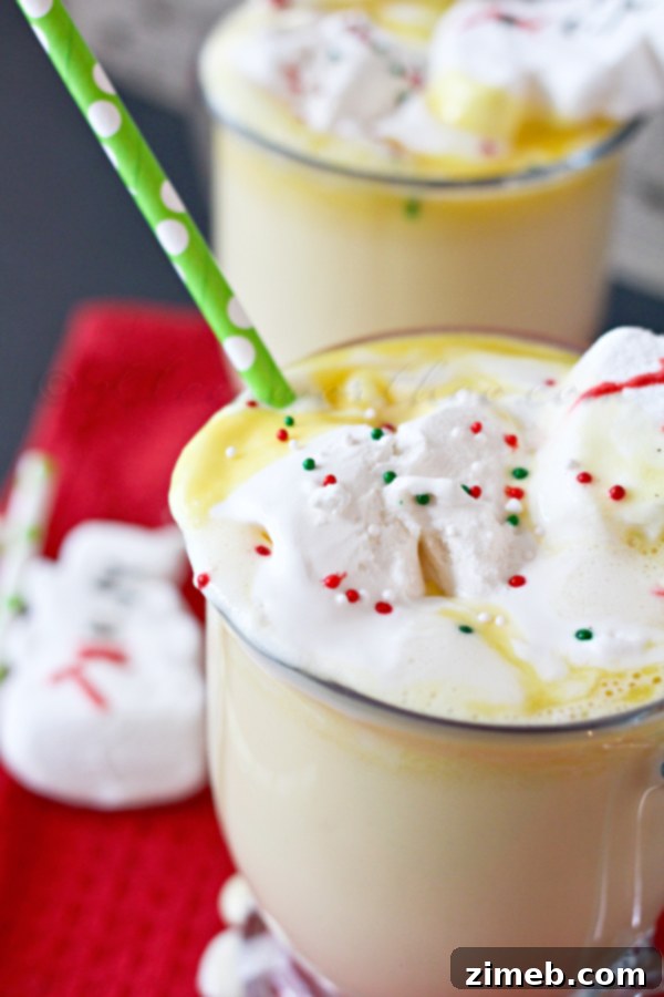 Several mugs of Eggnog Hot Chocolate, beautifully garnished and ready to serve