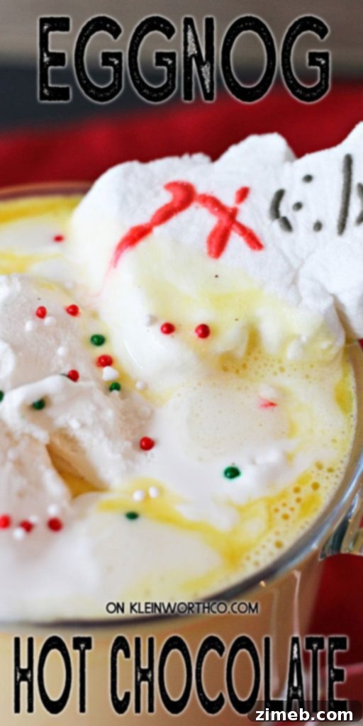 Eggnog Hot Chocolate in a tall glass mug with a candy cane, snowman Peep, and sprinkles