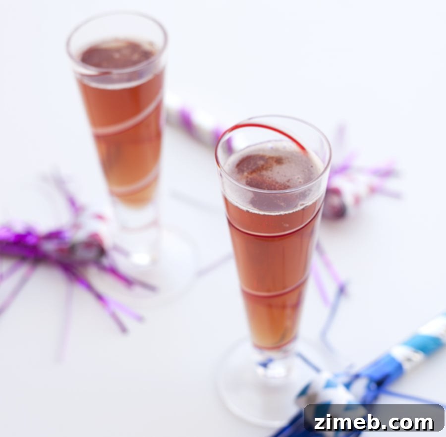 Close-up of Sparkling Cider New Year’s Eve Mocktails, garnished with pomegranate seeds.