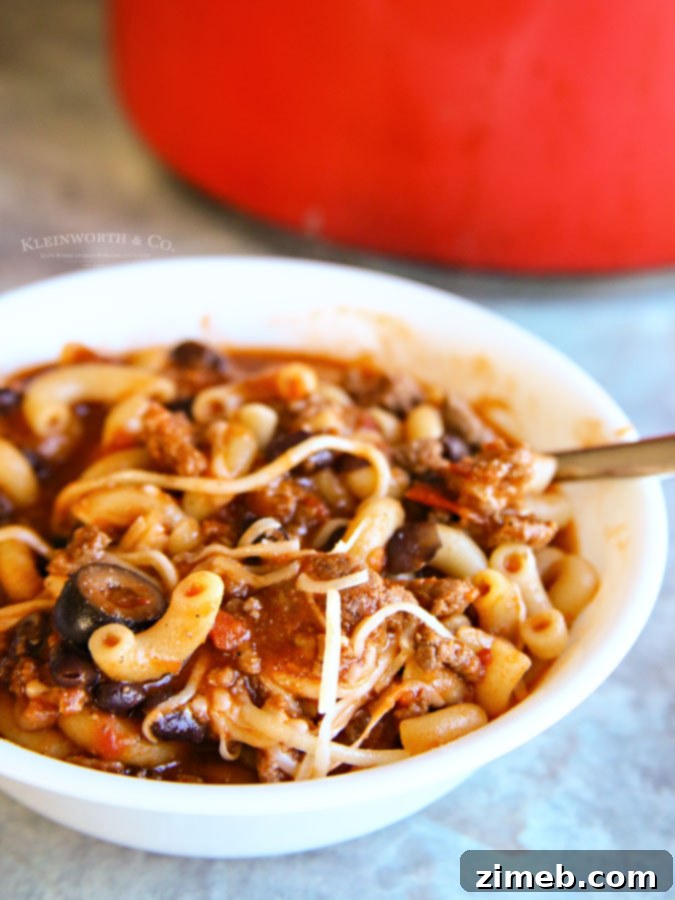 Close-up of a bowl of Beef Macaroni Soup, showcasing the macaroni, beef, and tomato broth, a true comfort food