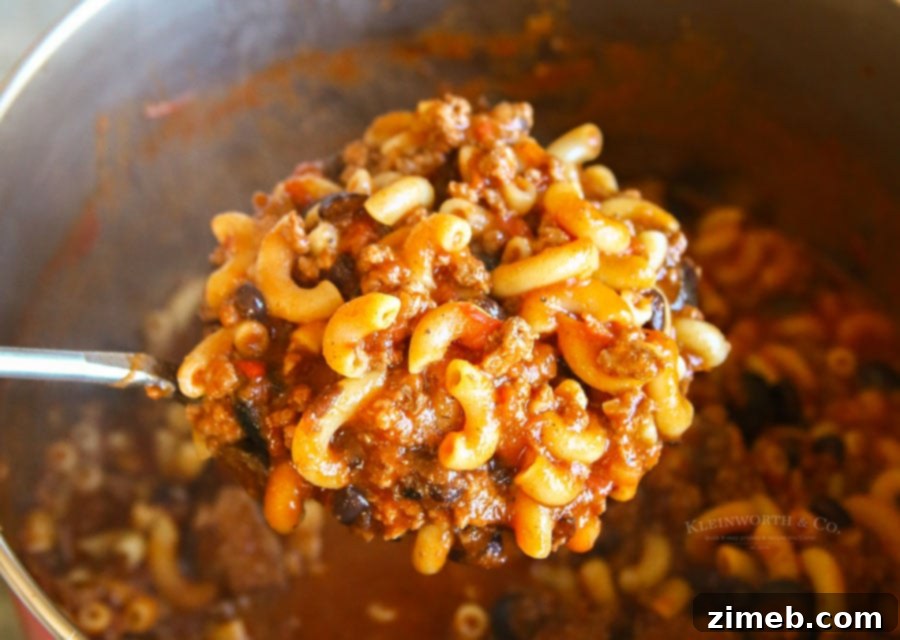 Homemade easy beef macaroni soup simmering in a pot, ready for family dinner