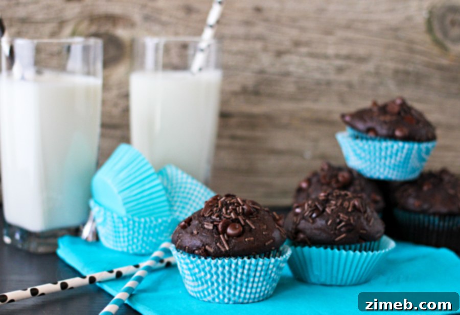 Ultimate Chocolate Muffins 5 Freshly baked Chocolate Overload Muffins on a cooling rack.