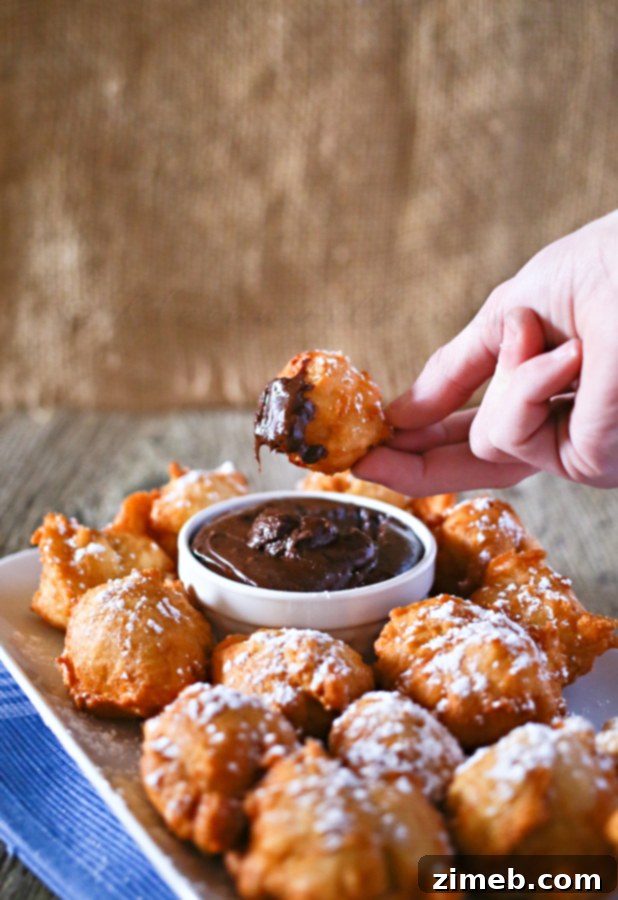 Zeppole: Italian Fried Delights 3 Freshly fried Zeppole cooling down on a rack