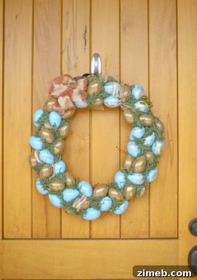 Elegant Blue and Gold Easter Wreath 4 DIY Blue & Gold Easter Wreath featuring a collection of painted faux eggs on a rustic grapevine base, ready for spring.