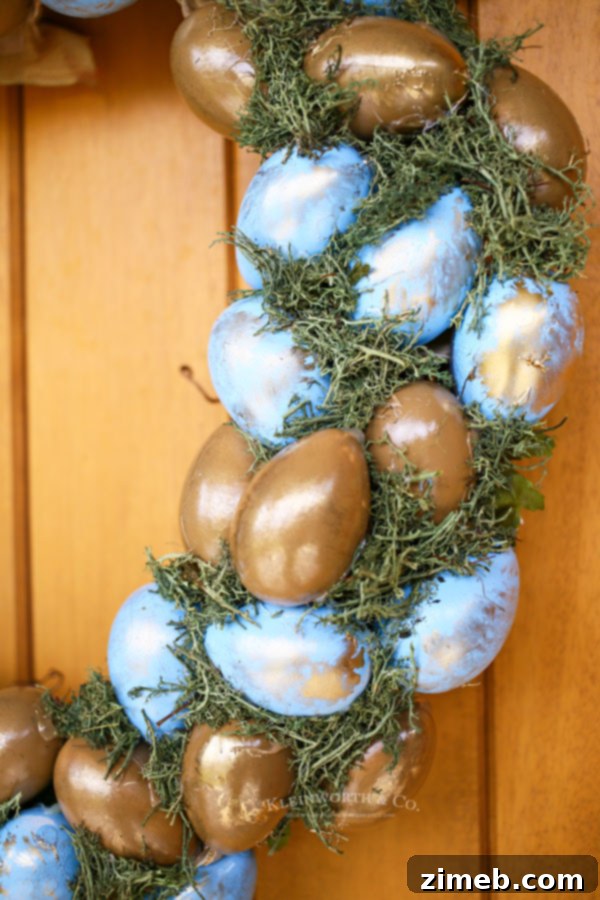 Elegant Blue and Gold Easter Wreath 5 Handcrafted spring wreath with blue and gold eggs, perfect for Easter door decorations and welcoming the new season.