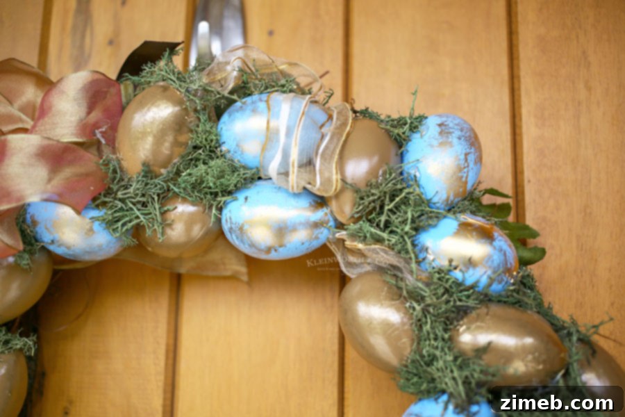 Elegant Blue and Gold Easter Wreath 6 Close-up of a beautiful Easter wreath made with painted faux eggs, showing off blue and subtle gold accents.