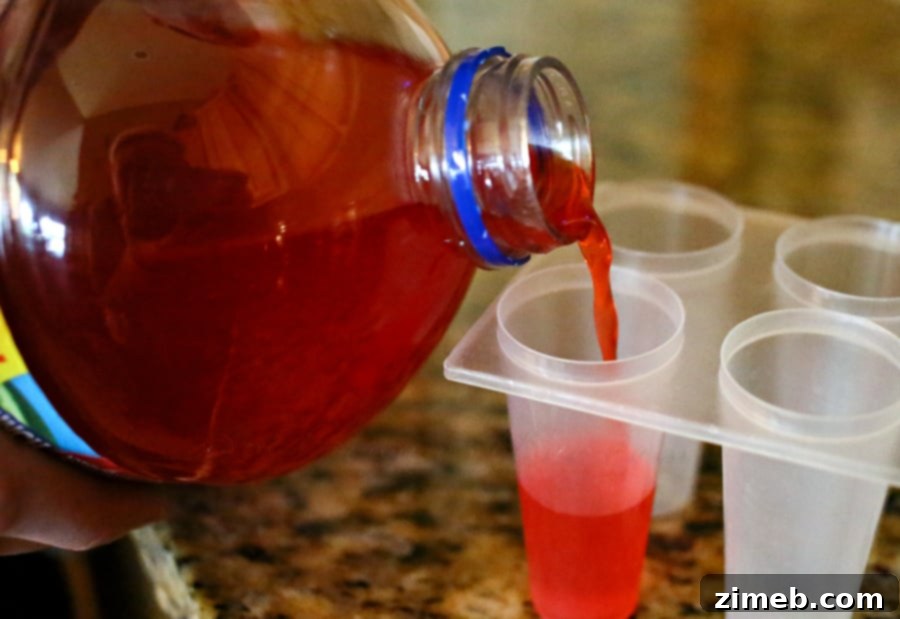 Quick & Cool Ice Pops 4 Kool-Aid powder sprinkled at the bottom of clear popsicle molds before filling.