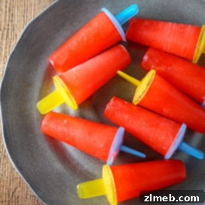 Quick & Cool Ice Pops 8 Close-up of a homemade Kool-Aid popsicle, showcasing its vibrant color and frosty texture.