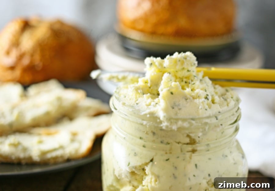 Italian Garlic Butter Warm dinner rolls with Italian garlic butter spread, on a wooden board.