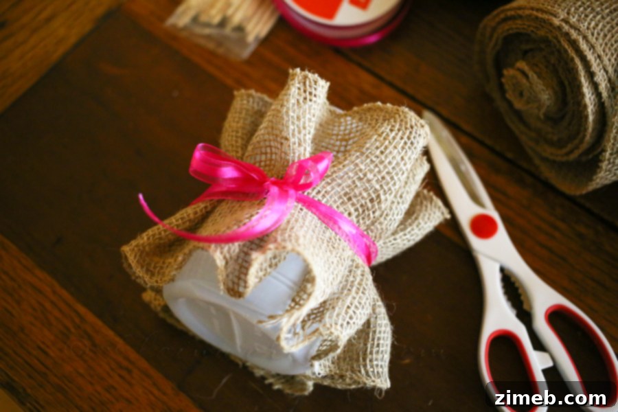 Stunning Easter Table Centerpiece 5 Applying burlap to bottle