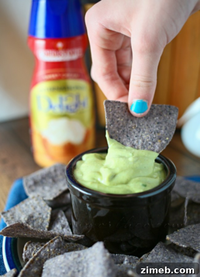 Creamy Sweet Garlic Avocado Dip 4 Sweet Garlic Avocado Dip served in a bowl with a variety of colorful blue and yellow tortilla chips, ready for dipping. www.kleinworthco.com