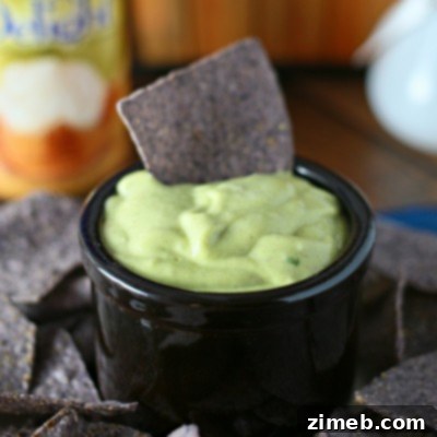 Creamy Sweet Garlic Avocado Dip 6 Sweet Garlic Avocado Dip in a white bowl with a spoon