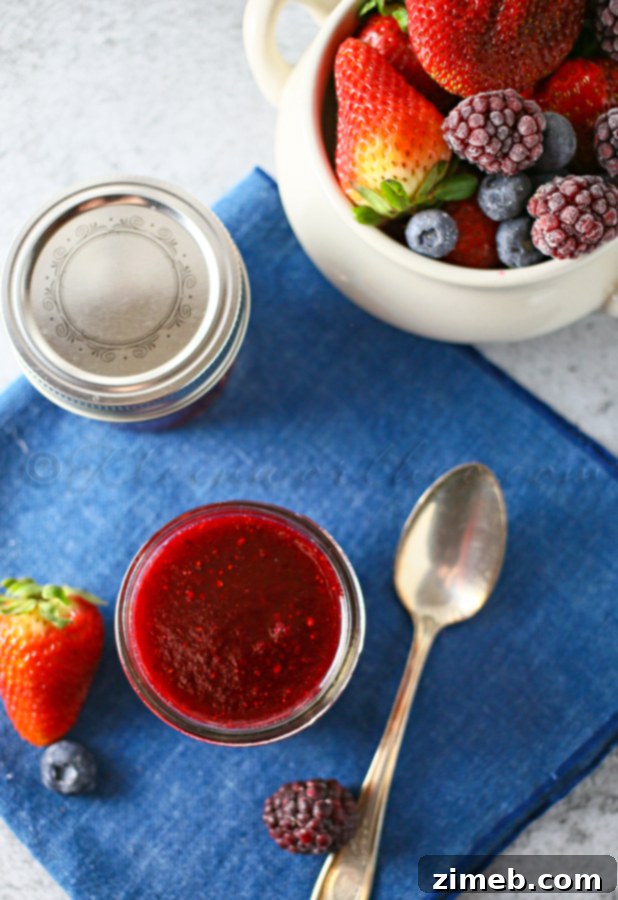 A close-up of the vibrant Triple Berry Sauce in a bowl, showcasing its rich texture and color.