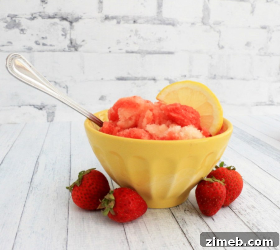Zesty Berry Bliss Sorbet 5 A bowl of freshly scooped Strawberry Lemon Sorbet, garnished with fresh mint leaves, ready to be enjoyed.