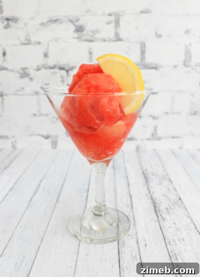 Zesty Berry Bliss Sorbet 6 Close-up of a generous serving of homemade Strawberry Lemon Sorbet with a spoon, highlighting its creamy, inviting texture.