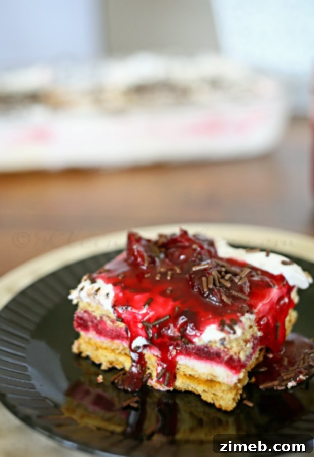 Close-up of Cherry Pie Ice Box Cake showing creamy layers and graham cracker crust.
