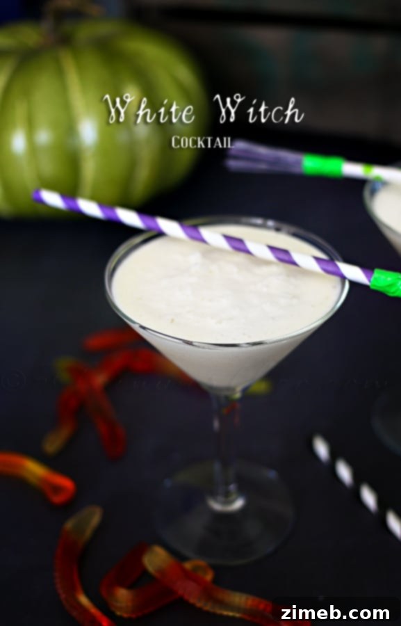 Kid-friendly White Witch Mocktail, called Ghostly Glow Mocktail, in a decorated glass