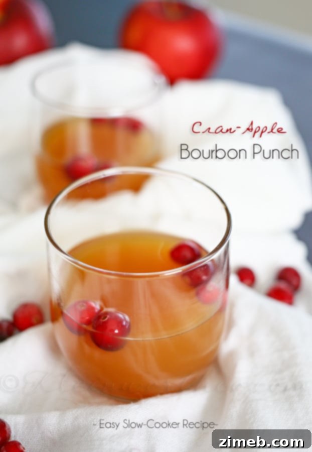 A large serving bowl of Cran-Apple Bourbon Punch in a slow cooker, ready for guests