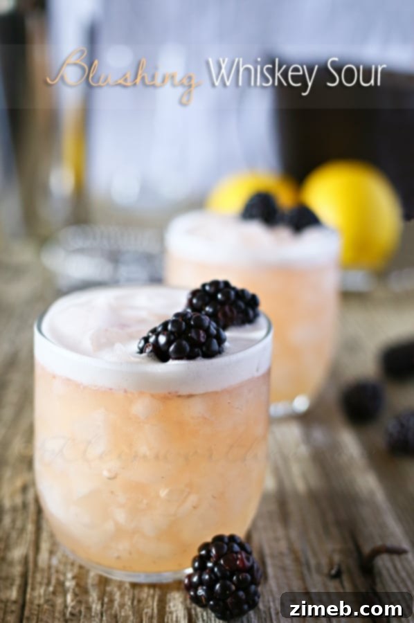 Crimson Ember 7 Blushing Whiskey Sour cocktail in a coupe glass, garnished with a cherry.