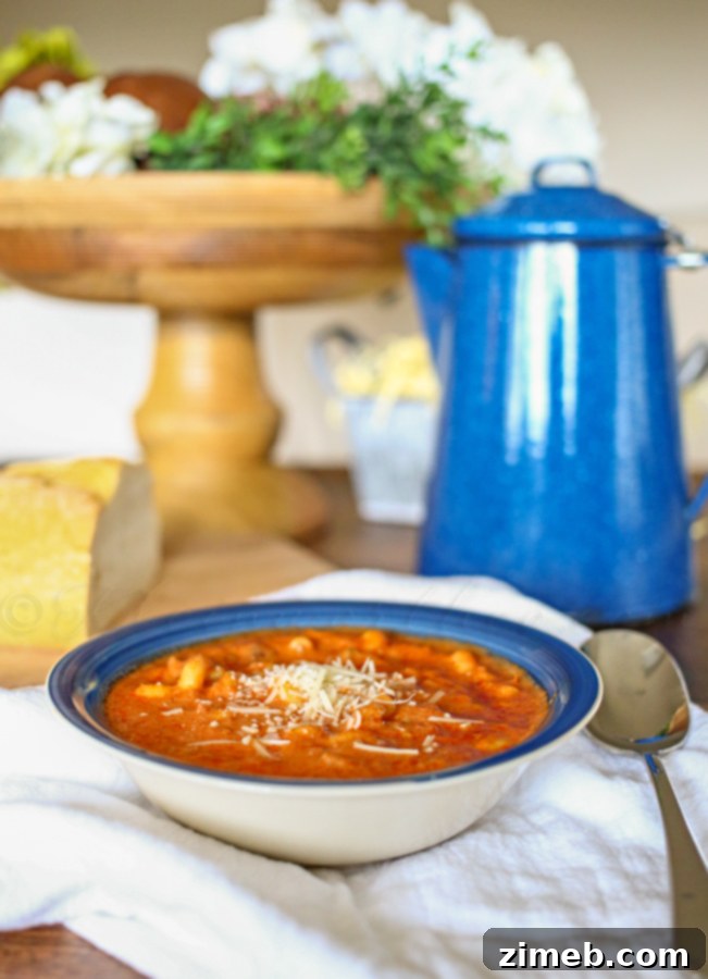 Hearty Tomato Soup Family Dinner Made Easy 3 Close-up of creamy Hearty Tomato Soup with hints of savory sausage and pasta