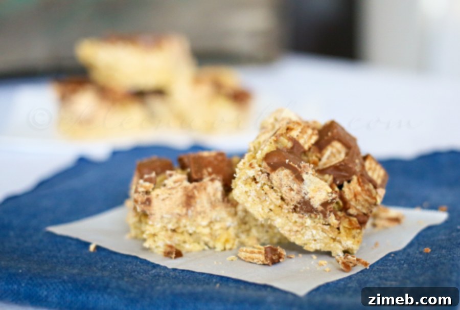 Quick & Delicious Kit Kat Oatmeal Bars Close-up of freshly made Kit Kat Oat Bars, showcasing their layers and inviting texture.