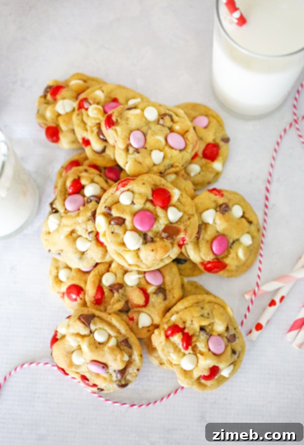 Valentine Chocolate Chip Cookies A close-up of a single Valentine Chocolate Chip Cookie, showing the rich, melted chocolate and colorful M&M's against a soft cookie base.