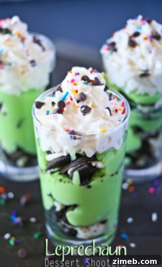 Pot o' Gold Dessert Shooters 6 A close-up of a single Leprechaun Dessert Shooter with a spoon, highlighting its inviting layers.