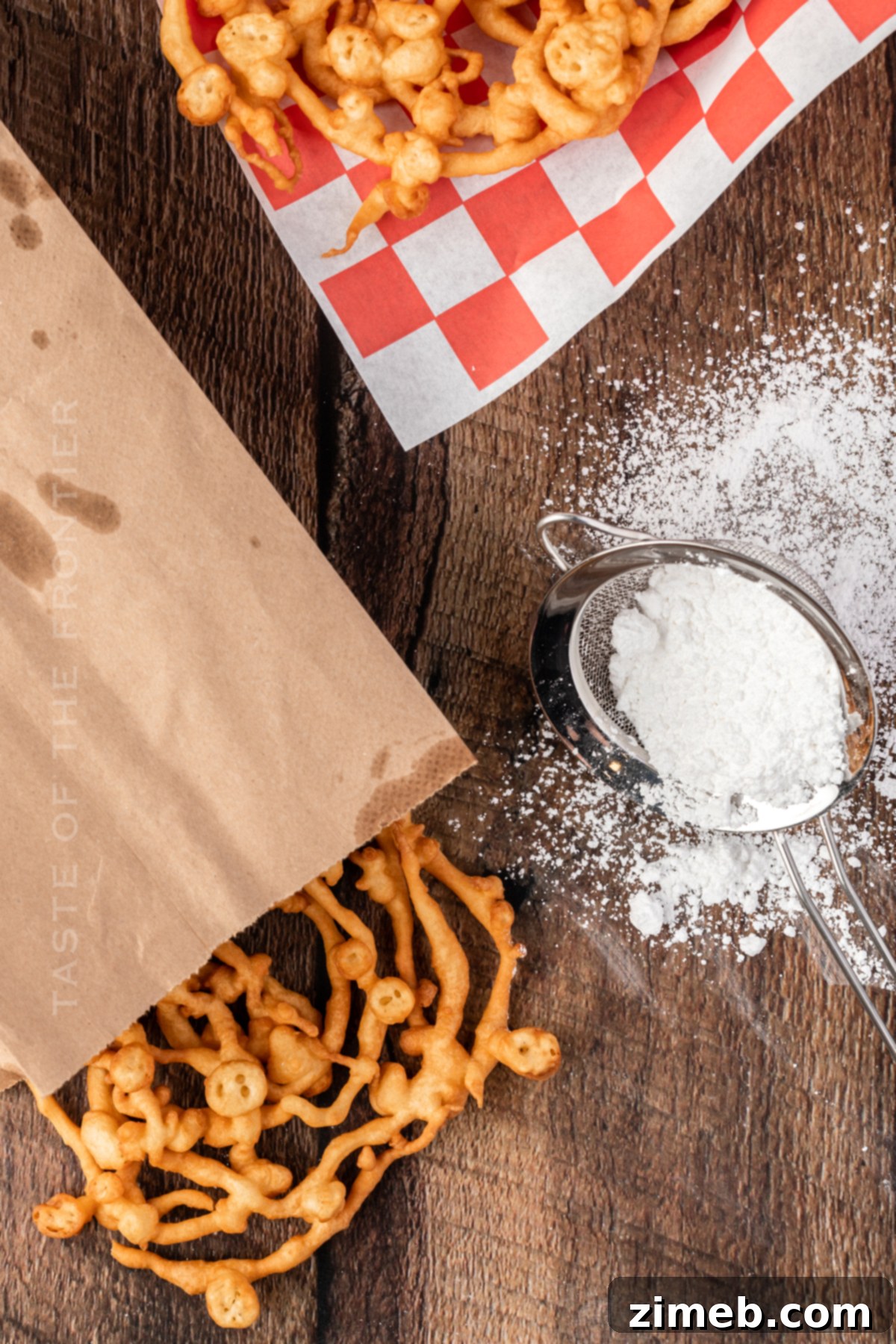 Adding confectioner's sugar to a stack of Funnel Cakes for the finishing touch.