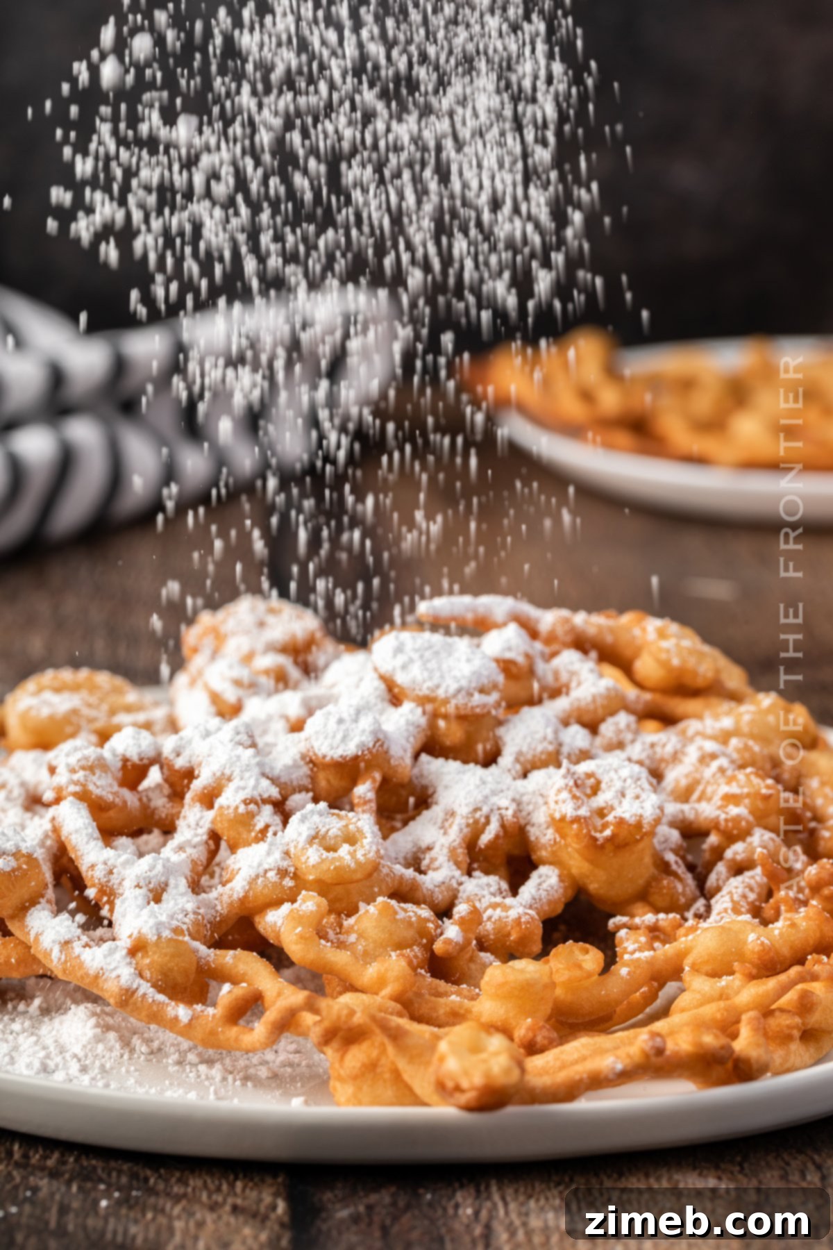 A beautiful stack of Funnel Cakes, fresh from the fryer and ready to be topped.