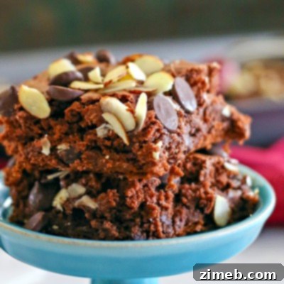 Effortless Dark Chocolate Almond Dream 4 Dark Chocolate & Almond Dump Cake, showcasing a slice with rich chocolate and almond topping on a plate.
