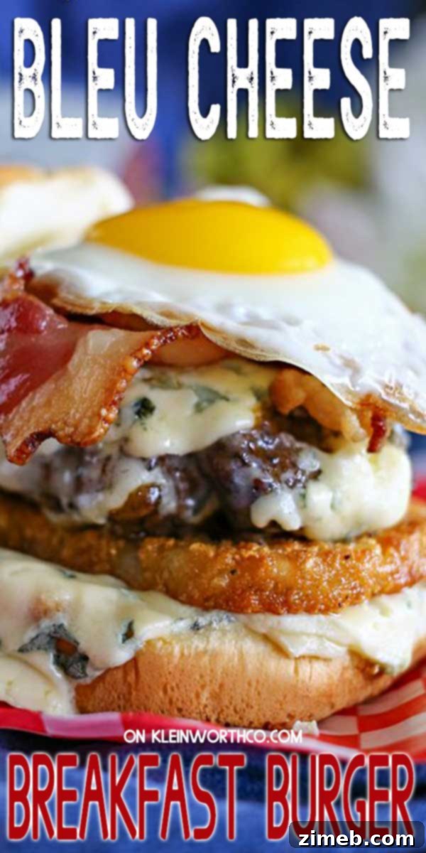 Blue Cheese Sunrise Stack 2 A gourmet Blue Cheese Breakfast Burger, layered with hash browns, a ground chuck patty, bacon, and a sunny-side-up egg, showcasing the rich, melted blue cheese.