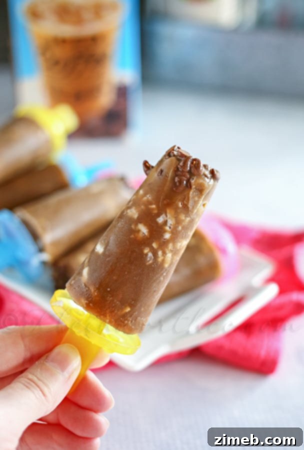 Hand holding a Coconut Mocha Pop with a bite taken out