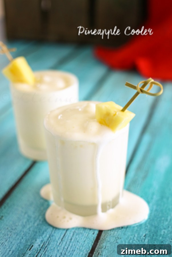 Tropical Pineapple Chill 4 Ingredients for Pineapple Cooler laid out, including pineapple chunks and cream.