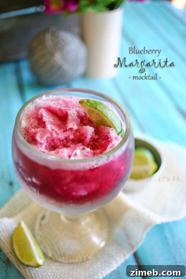 Blueberry Margarita Mocktail in a salt-rimmed glass.