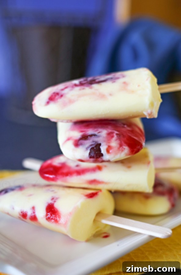 Refreshing Cherry Pie Pops, a perfect frozen treat with creamy vanilla and sweet cherry swirl