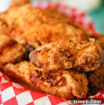 Close-up of the ingredients for buttermilk chicken strips, including chicken, buttermilk, flour, and spices