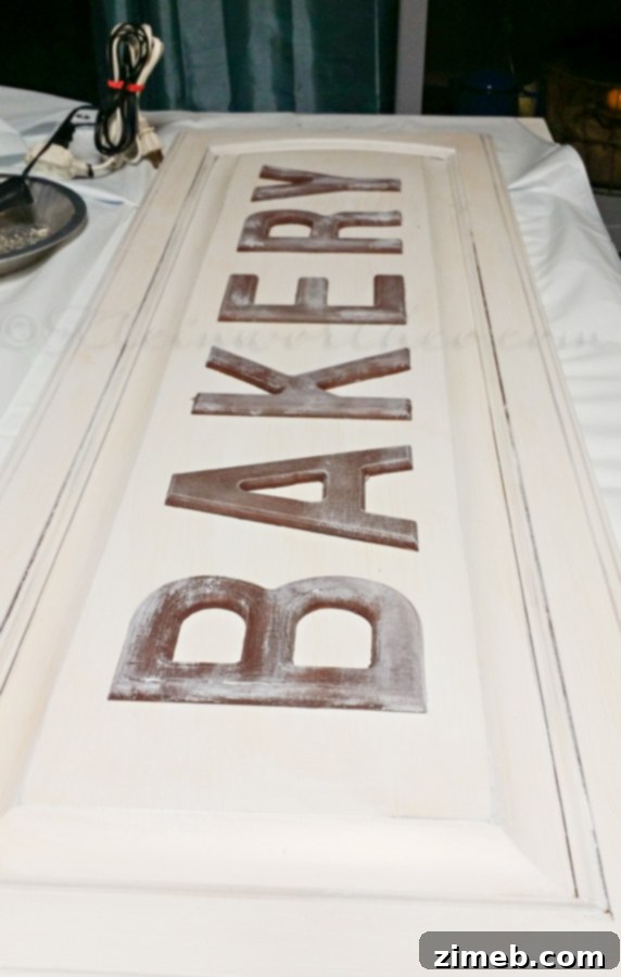 Antique Patisserie Plaque 6 Applying whitewash to the cabinet door