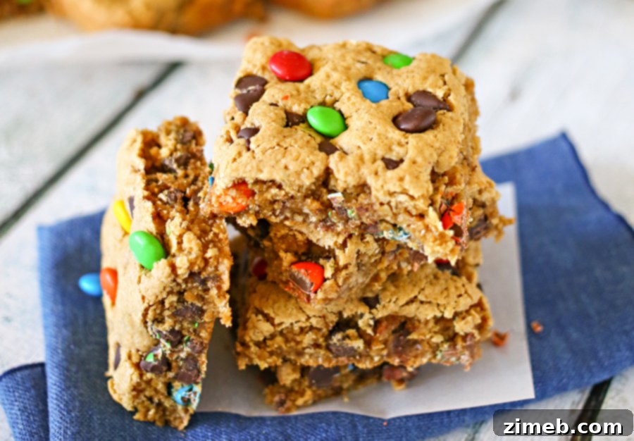 Kitchen Sink Cookie Bars 3 Close-up of freshly baked Monster Cookie Bars, showing melted chocolate and colorful M&M's.