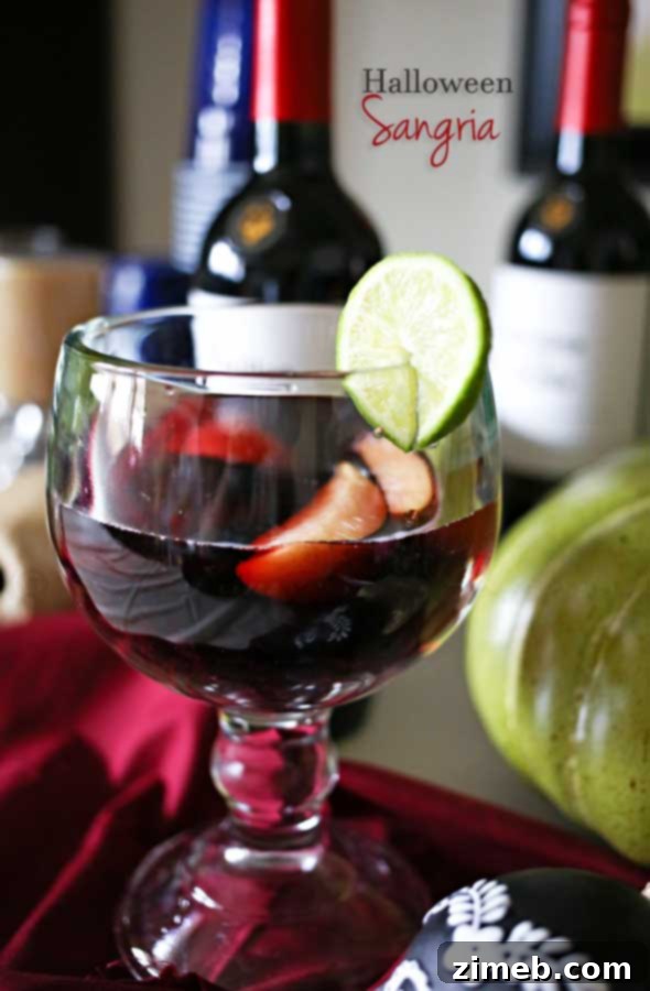 Dark and Spooky Halloween Sangria in a pitcher with fresh fruit