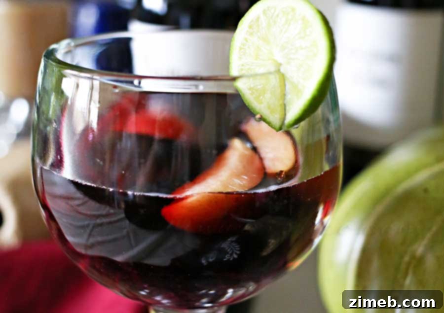 Individual glasses of Halloween Sangria with various dark fruits