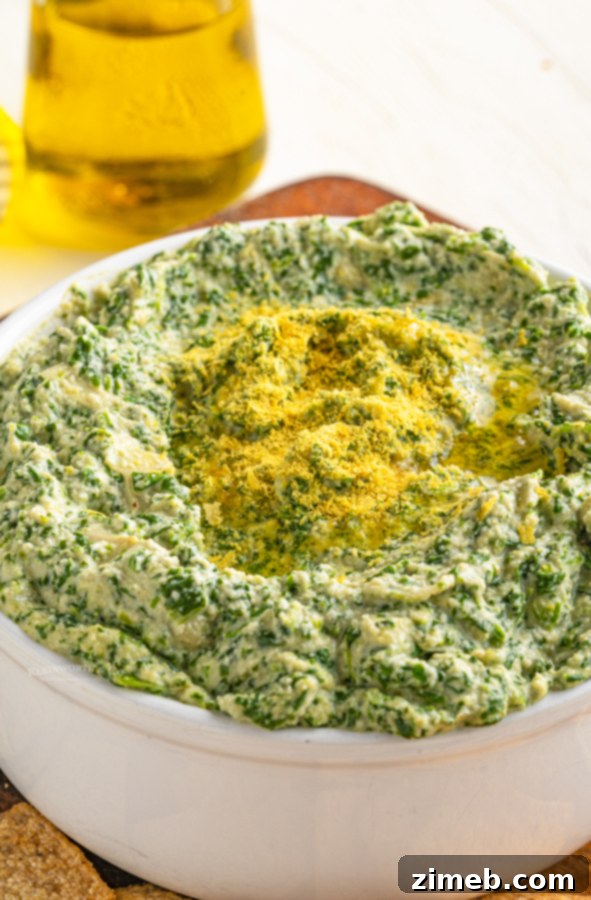 Irresistible Vegan Spinach Artichoke Dip 17 Vegan appetizer: Warm and creamy spinach artichoke dip served with fresh bread.