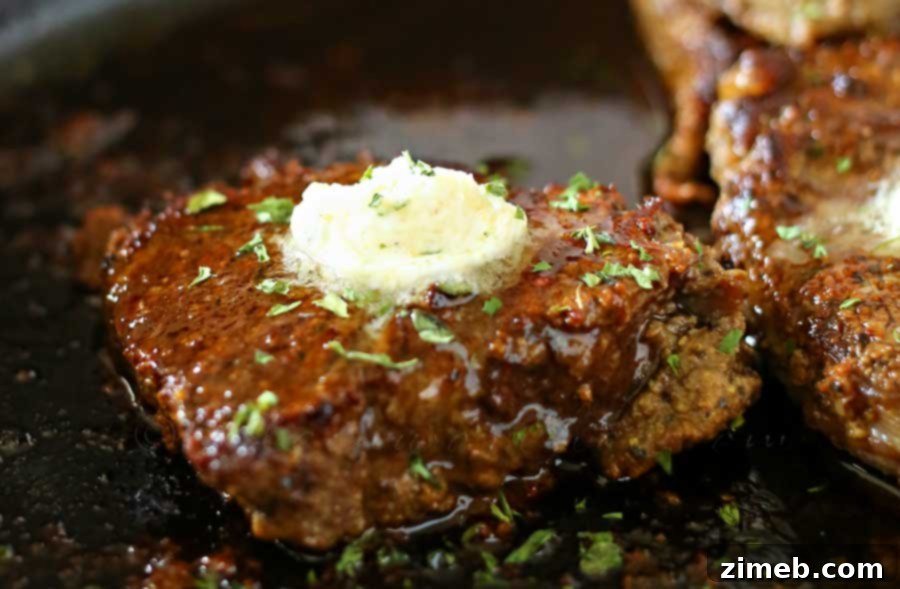 Close-up of a perfectly cooked Garlic Butter Filet Mignon, showcasing its tender texture and rich butter sauce, ideal for an easy family dinner.