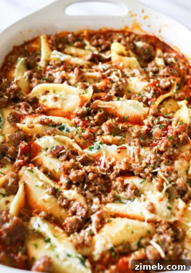 Baked Stuffed Shells 3 Easy Stuffed Shells baking in a casserole dish, topped with melted cheese and sauce.