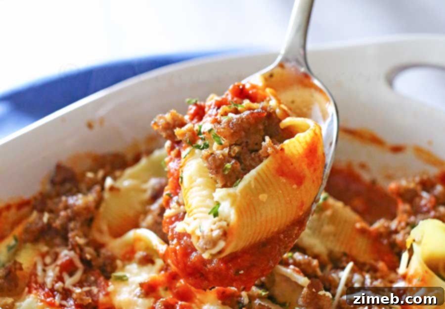 Baked Stuffed Shells 4 A close-up of cheesy Stuffed Shells with marinara and sausage, fresh from the oven.