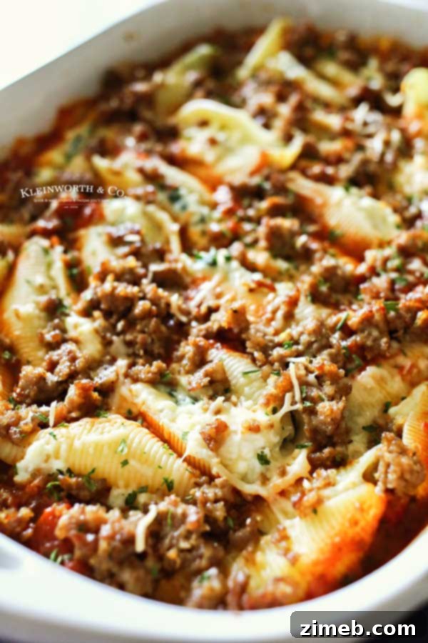 Baked Stuffed Shells 6 Sausage Stuffed Shells baking in a casserole dish.